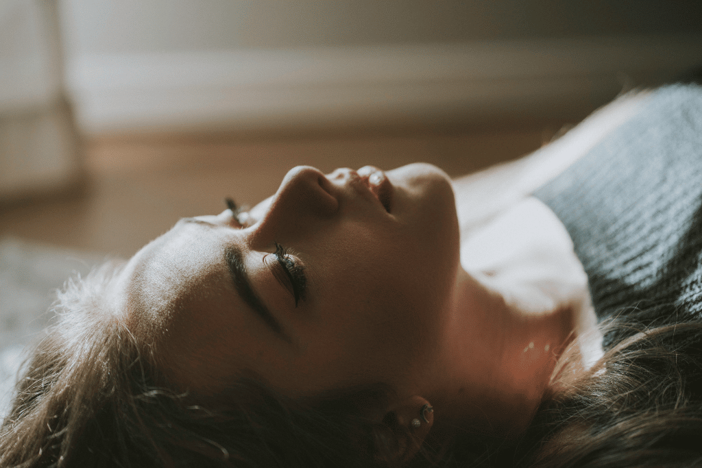 A young woman lying down in a rehab therapy session | Which Rehab