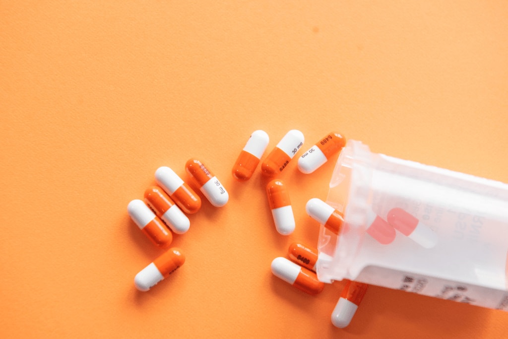 A bag of pills spilling on to a table - Can you quit drugs without rehab blog - Which Rehab