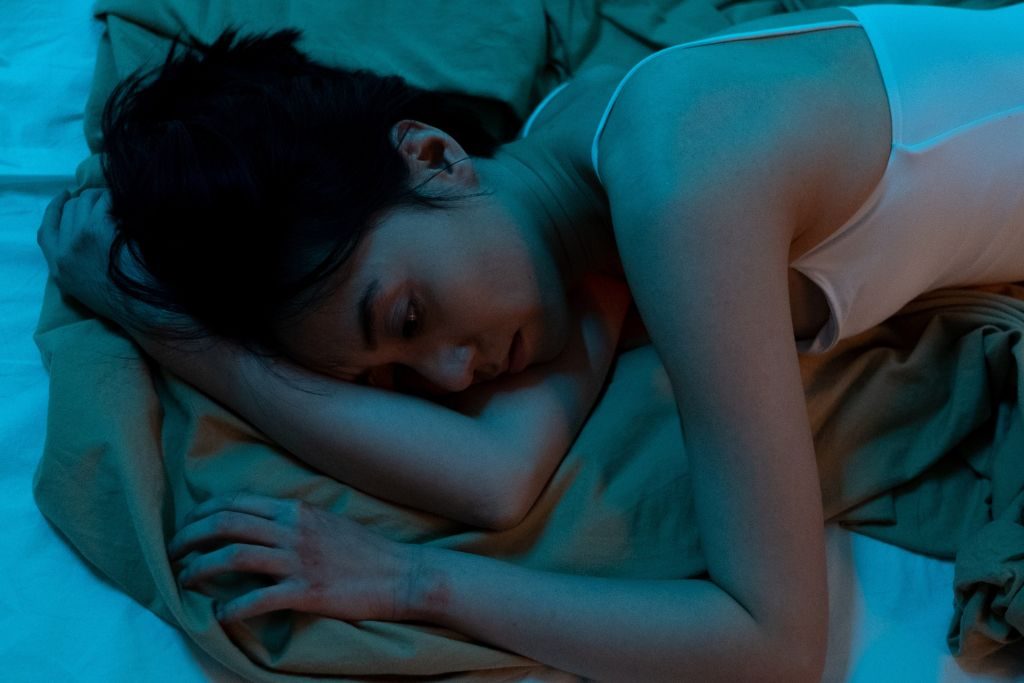 Woman lying awake in bed - Which Rehab